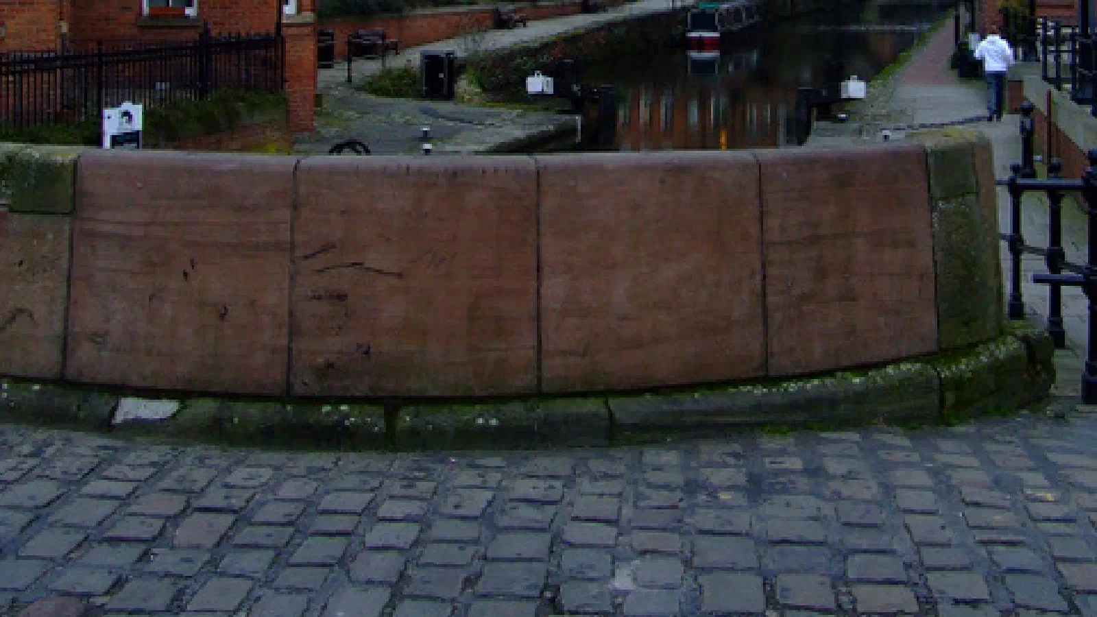 Brick structures line a canal under an overcast sky, contrasting with a modern glass skyscraper. — Beetham Tower, Manchester