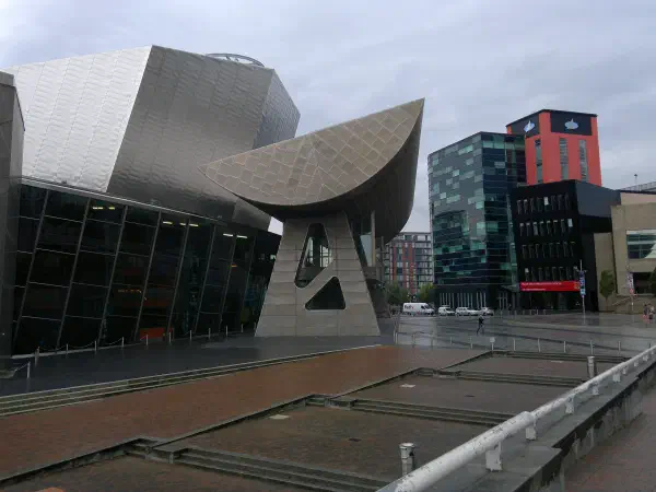 Overcast city scene with modern architecture featuring glass facades, metal structures and geometric designs. — The Lowry, Manchester